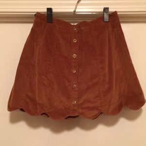 Tan suede scalloped mini skirt with buttons